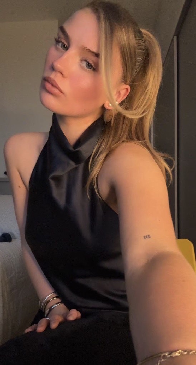 Rachel in a black satin halter top in warm evening light
