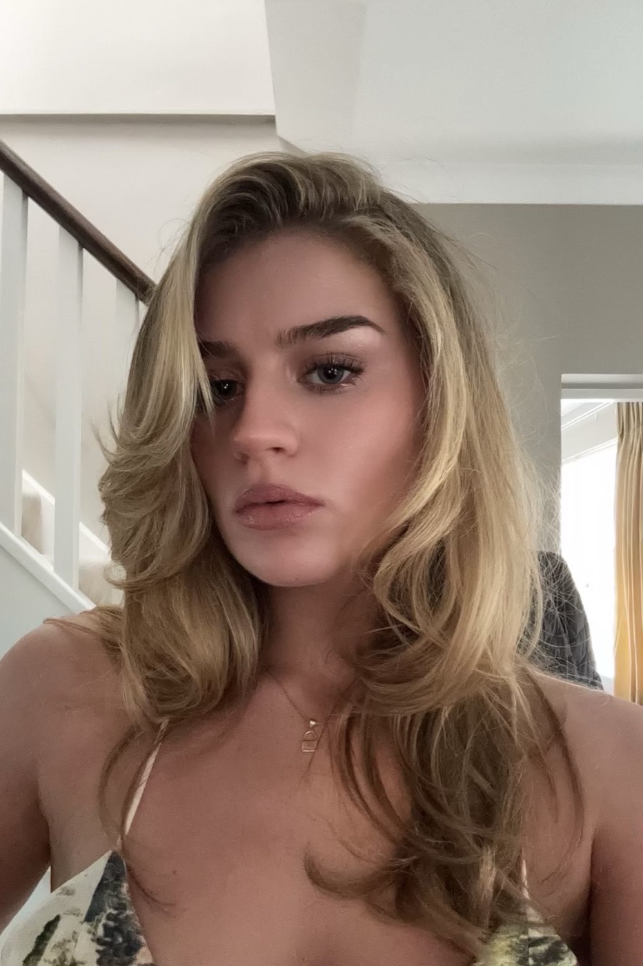 Rachel with voluminous blonde hair, looking at the camera