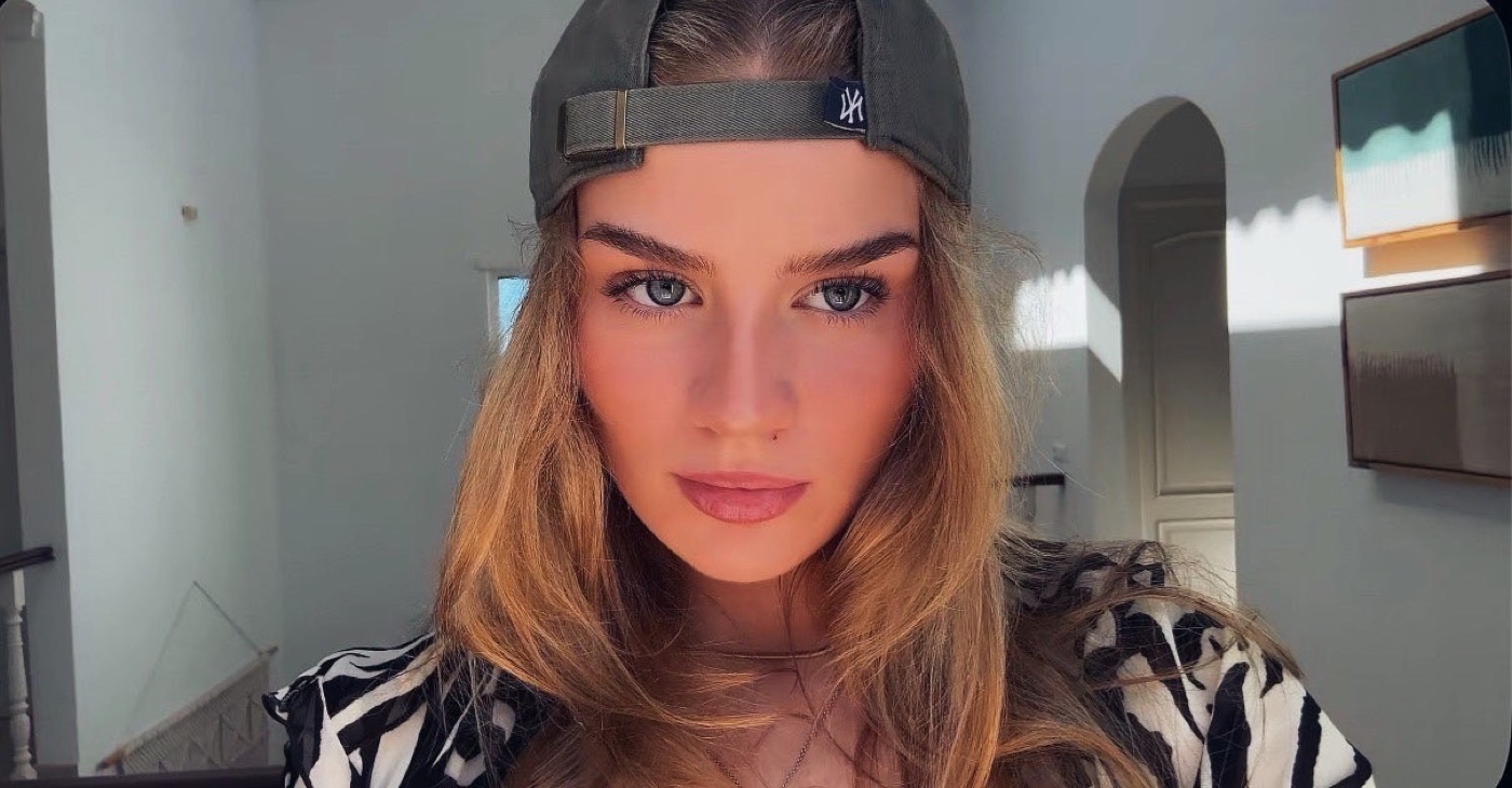 Close-up of Rachel in a backwards cap and zebra-print top